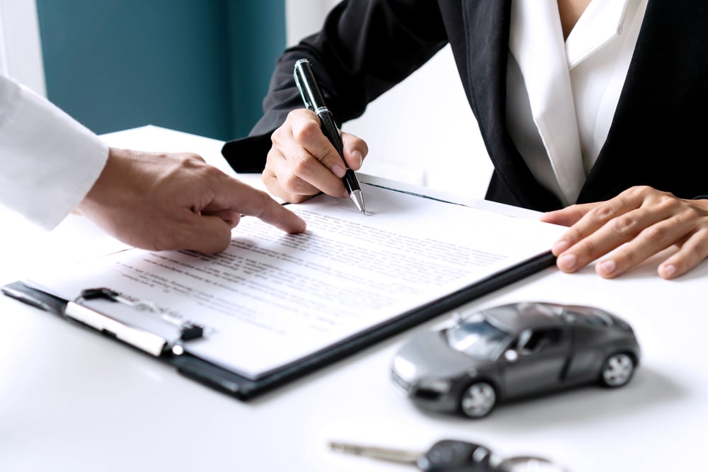 Photo of a Person Signing Documents